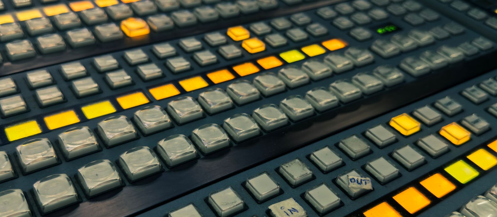 Illuminated buttons on a broadcast production switcher